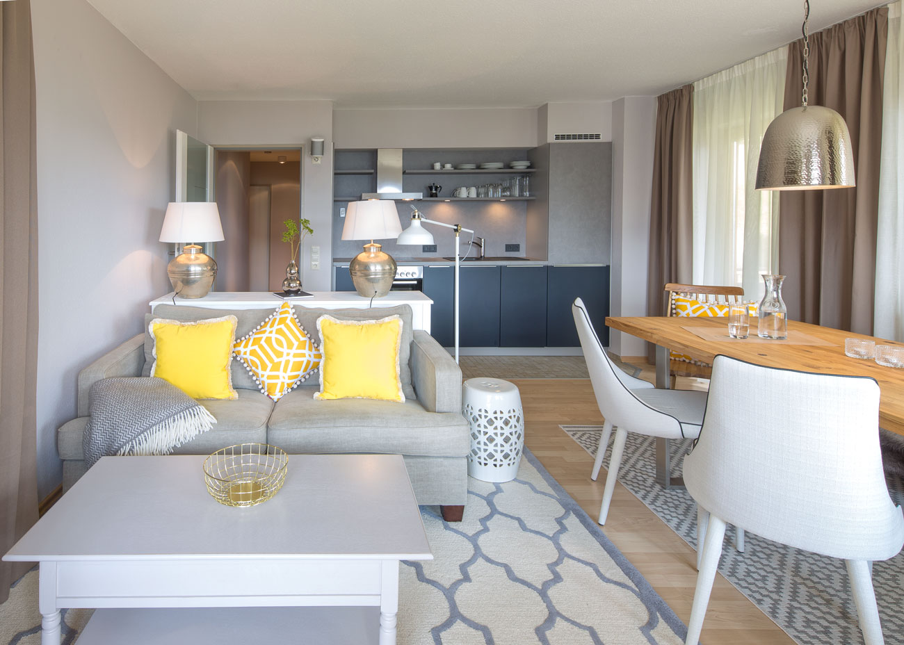 Wohnung gemütlich einrichten wohnezimmer küche taupe couch holztisch stühle leuchte metall